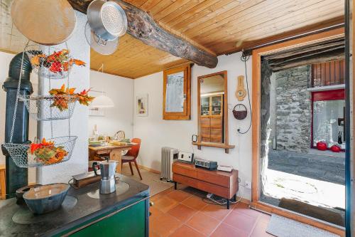 a kitchen with a counter and a table in a room at Rustico Stock with free wifi- Happy Rentals in Lugano