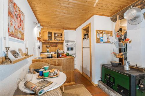 a small kitchen with a table and a counter at Rustico Stock with free wifi- Happy Rentals in Lugano