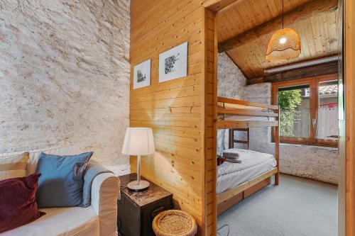 a room with a couch and a bunk bed at Rustico Stock with free wifi- Happy Rentals in Lugano
