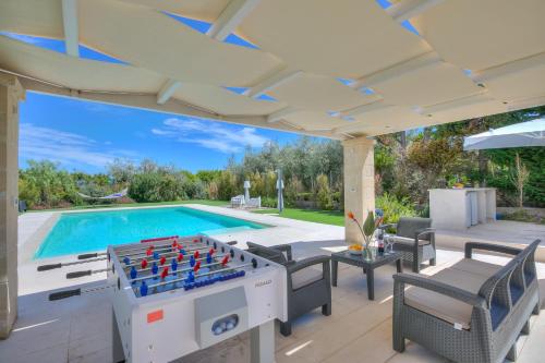 an outdoor entertaining area with a pool and a foosball table at Palazzo Biscilia with private pool - Happy Rentals in Bisceglie