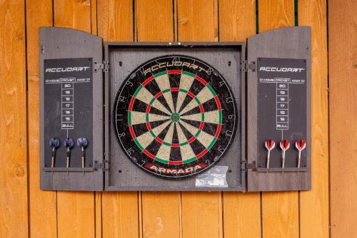 a dart board on a wooden wall with darts at 4-BD 3-FullBA SAMedical Cen,Riverwalk,Fiesta,Rodeo in San Antonio