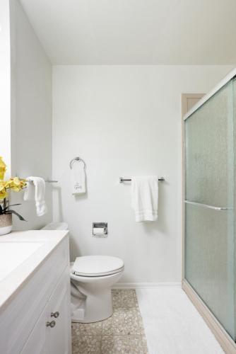a white bathroom with a toilet and a glass shower at 4-BD 3-FullBA SAMedical Cen,Riverwalk,Fiesta,Rodeo in San Antonio