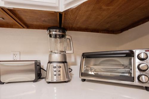 a blender on a counter next to a toaster oven at 4-BD 3-FullBA SAMedical Cen,Riverwalk,Fiesta,Rodeo in San Antonio
