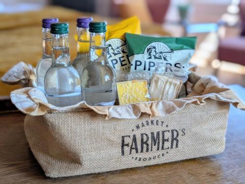 a basket filled with bottles of water and snacks at The Beach House Boutique Hotel in Sunderland