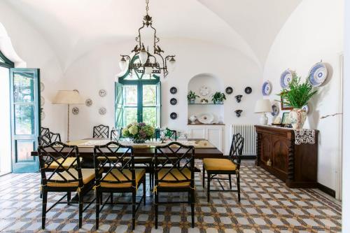 a dining room with a table and chairs at Villa Ginestra by Elite Villas in Capri