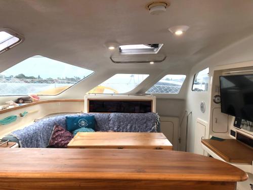 a table and a couch in the back of a boat at bocas Del toro Charter in Bocas del Toro