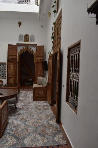 a living room with a couch and a fireplace at Hostel Capital in Rabat