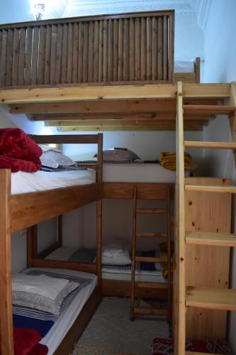 a bunk bed in a room with a bunk bedscribed at Hostel Capital in Rabat