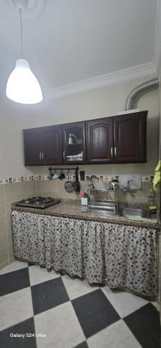 a kitchen with wooden cabinets and a counter top at Dar Tetuan 4 You II in Tetouan