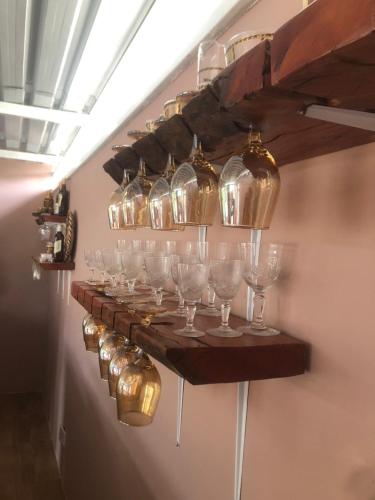 a row of wine glasses on a shelf on a wall at 1 bed apartment in Mount Pleasant Heights - 2014 in Kingsmead
