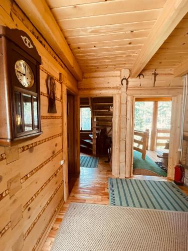 a wooden room with a clock on the wall at Szmer Soliny in Werlas
