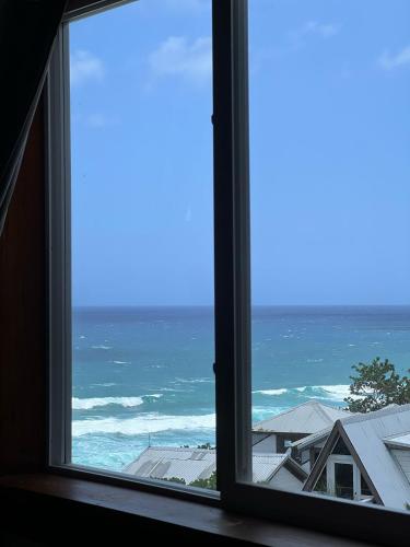 a view of the ocean from a window at The Sea Cliff Hotel Resort & Spa in Port Antonio
