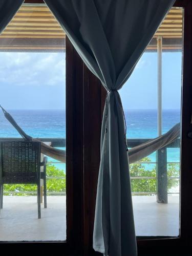 a view of the ocean from a room with a window at The Sea Cliff Hotel Resort & Spa in Port Antonio