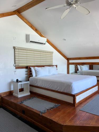 a bedroom with a large bed and a ceiling at The Sea Cliff Hotel Resort & Spa in Port Antonio