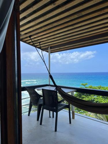 a hammock on a balcony overlooking the ocean at The Sea Cliff Hotel Resort & Spa in Port Antonio