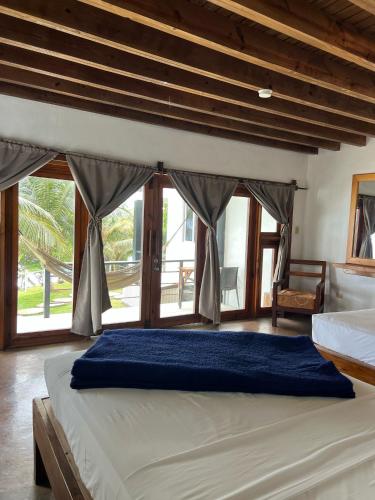 a bedroom with a large bed with a large window at The Sea Cliff Hotel Resort & Spa in Port Antonio