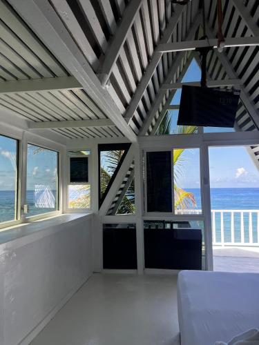 a living room with a view of the ocean at The Sea Cliff Hotel Resort & Spa in Port Antonio