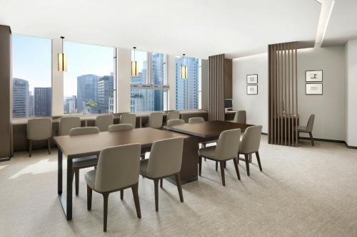 a conference room with a table and chairs and windows at Courtyard by Marriott Seoul Namdaemun in Seoul