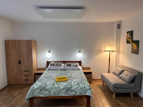 a bedroom with a bed and a couch and a chair at Dom Nad Jeziorem Trzy Tonie in Silna Nowa