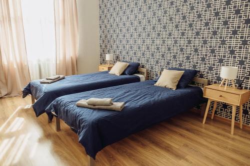 a bedroom with two beds with towels on them at Telegrāfs Hotel in Ventspils