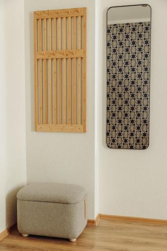 a chair and a window in a room at Telegrāfs Hotel in Ventspils