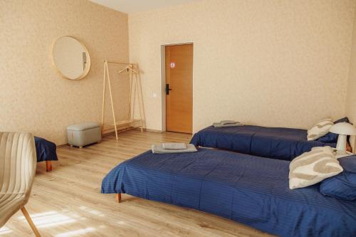 a room with two beds and a mirror at Telegrāfs Hotel in Ventspils