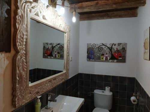 a bathroom with a mirror and a sink at El Sueño De Lucrecia in Villarrubia de Santiago
