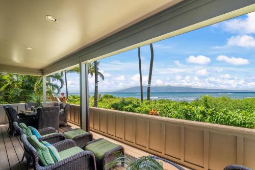 a balcony with chairs and a view of the ocean at Kahana Village 31 · KHV 31 Spacious Direct Oceanfront 3BD Condo in Kahana