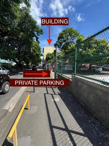 a parking lot with a building and parachute parking at Matavai Two in Papeete