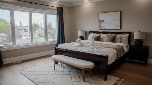 a bedroom with a large bed with two birds on it at Upscale Pickering Escape Near Lake & Dining in Pickering