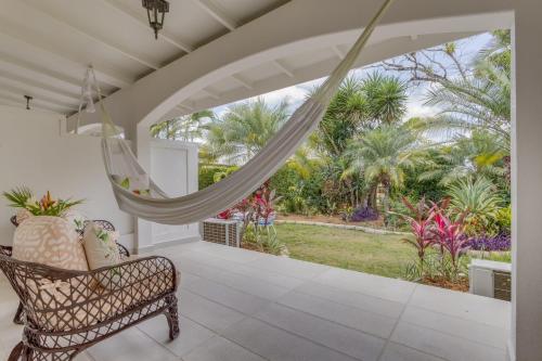 a porch with a hammock and a view of the garden at San Ignacio Resort Hotel in San Ignacio