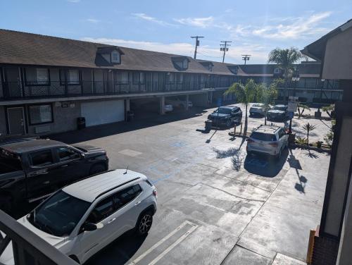 a parking lot with cars parked in front of a building at Cabana Inn & Suites in Long Beach