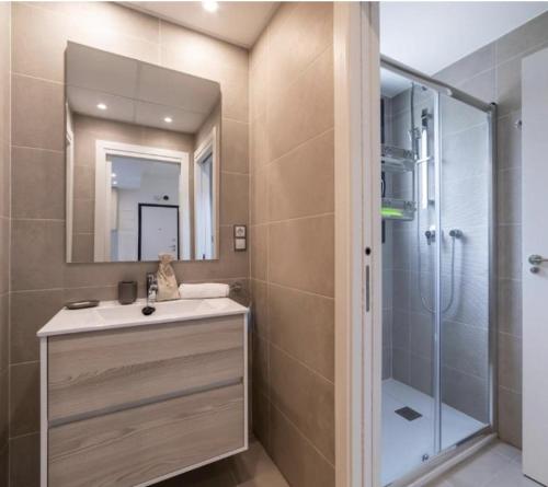 a bathroom with a sink and a shower with a mirror at Sea Arenales del Sol in Arenales del Sol