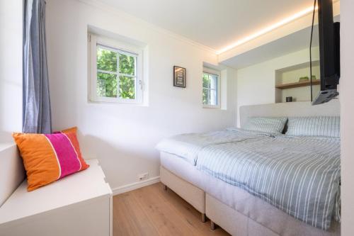 a bedroom with a bed and a window at Chalet Gaertli in Thun