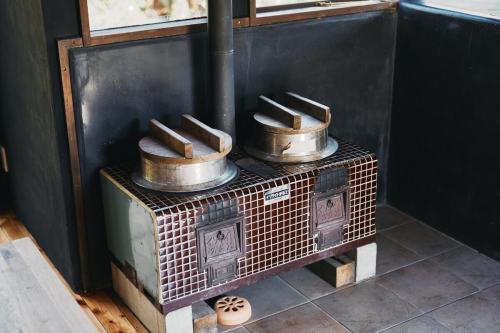 an old stove with pots and pans on top of it at THE NEST 森の灯 MUNAKATA by ritomaru in Munakata