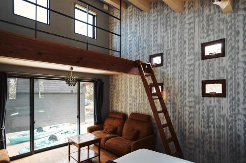 a living room with a loft bed and a ladder at THE NEST 森の灯 MUNAKATA by ritomaru in Munakata