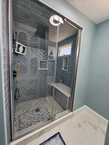 a shower with a glass door in a bathroom at Middletown Modern Townhouse in Middletown