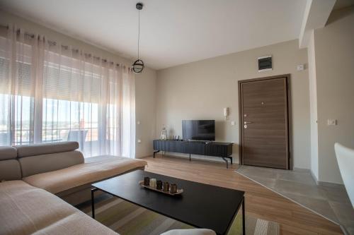 a living room with a couch and a table at Deluxe Apartments in Gevgelija