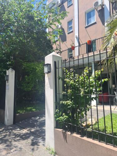 a fence in front of a building at Devoto Hotel Boutique in Buenos Aires