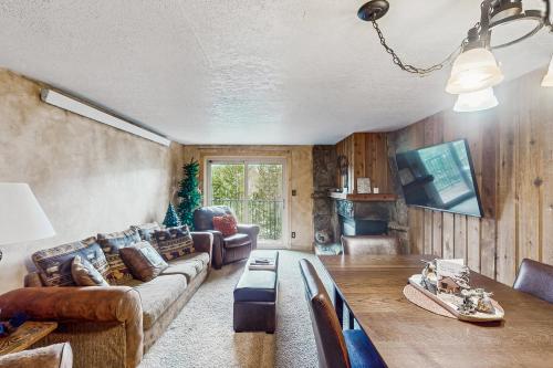 a living room with a couch and a table at Beaver Village in Winter Park