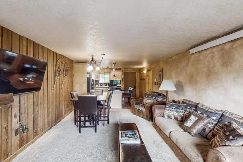 a living room with a couch and a table at Beaver Village in Winter Park