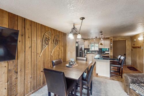 a kitchen and dining room with a wooden wall at Beaver Village in Winter Park