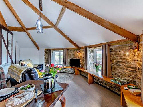 a living room with a stone wall at 1 bed in Tavistock ROUND in Lamerton