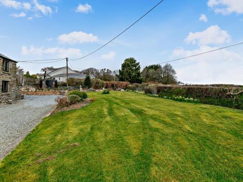 a field of green grass next to a house at 1 bed in Tavistock ROUND in Lamerton
