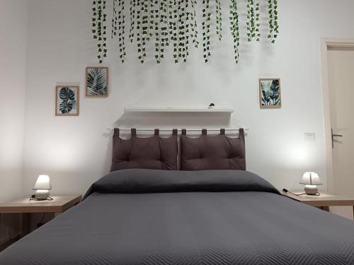a bedroom with a large bed with two night stands at Villa Calcerame in Montelepre