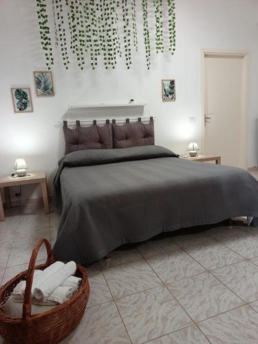 a bedroom with a large bed and a basket of towels at Villa Calcerame in Montelepre
