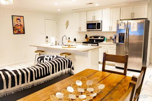 a kitchen and living room with a table and a refrigerator at Elvis' lovely home near Graceland in Memphis