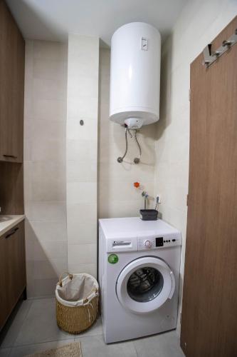 a laundry room with a washing machine and a light at Deluxe Apartments in Gevgelija