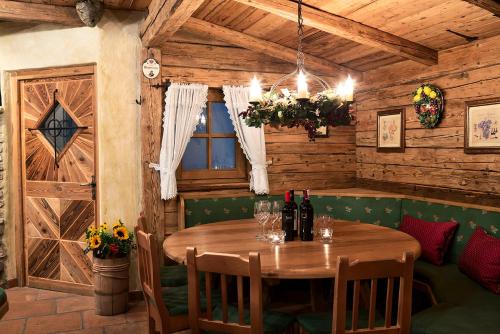 a wooden dining room with a wooden table and chairs at Hotel Auhof in Grossarl