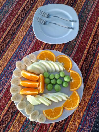 a plate of fruit and vegetables on a table at Paradise House in Pamukkale